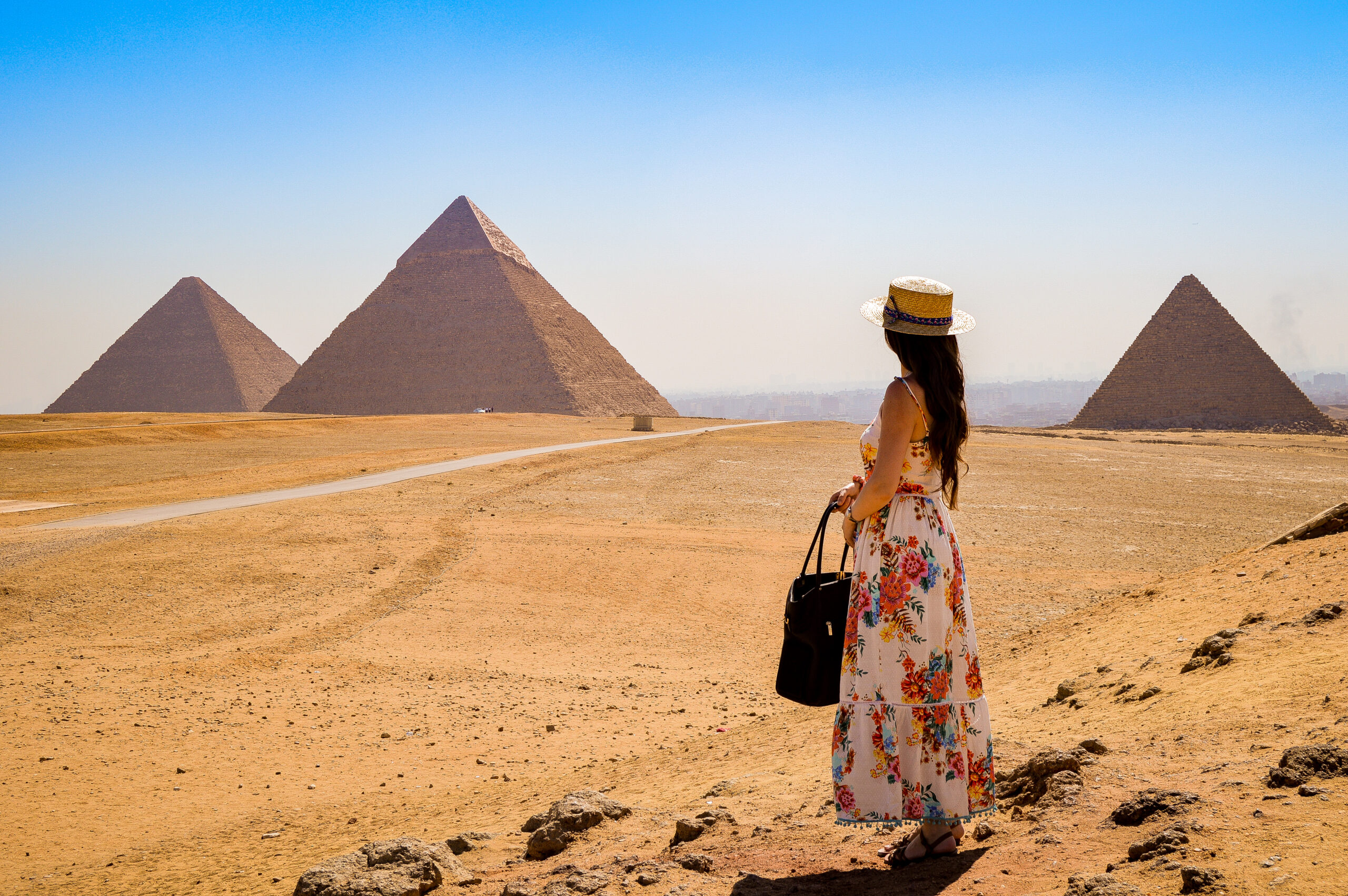 young-woman-visiting-pyramids-egypt-scaled